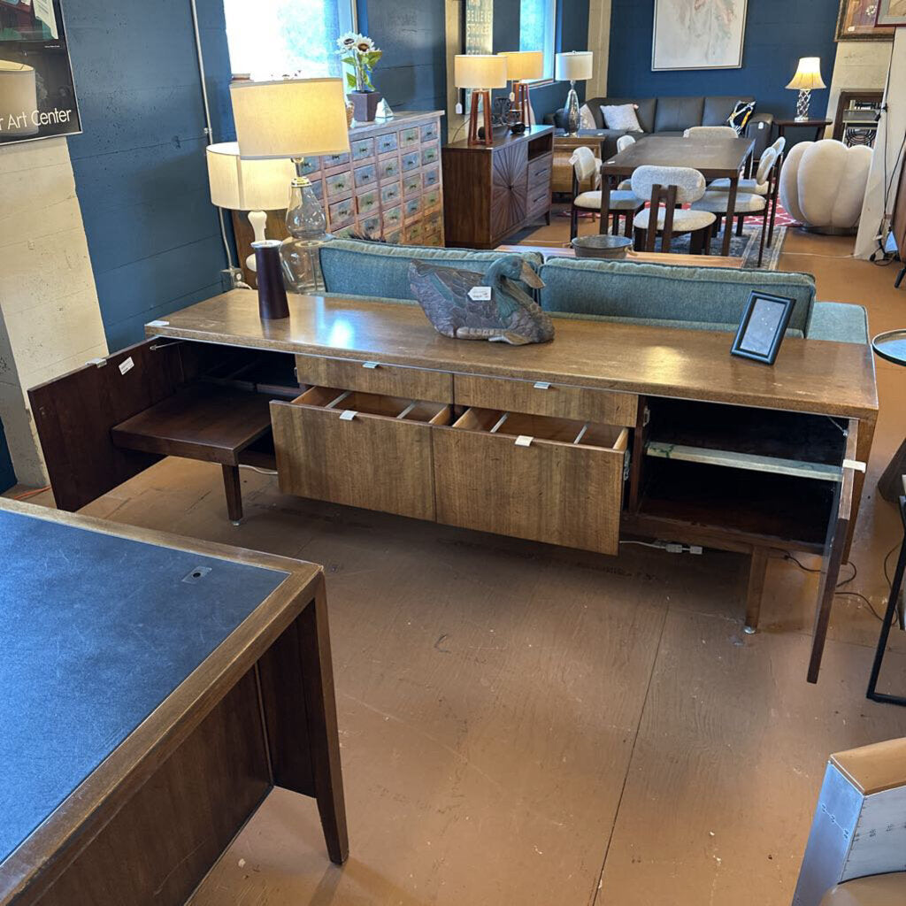 Wooden desk with drawers in a furniture store setting