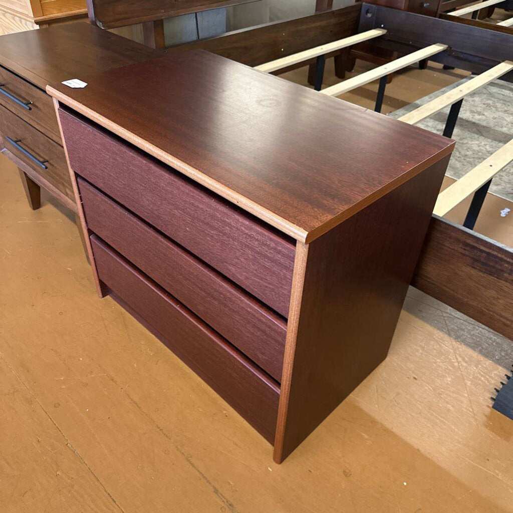 Wooden dresser with two drawers on a wooden floor.