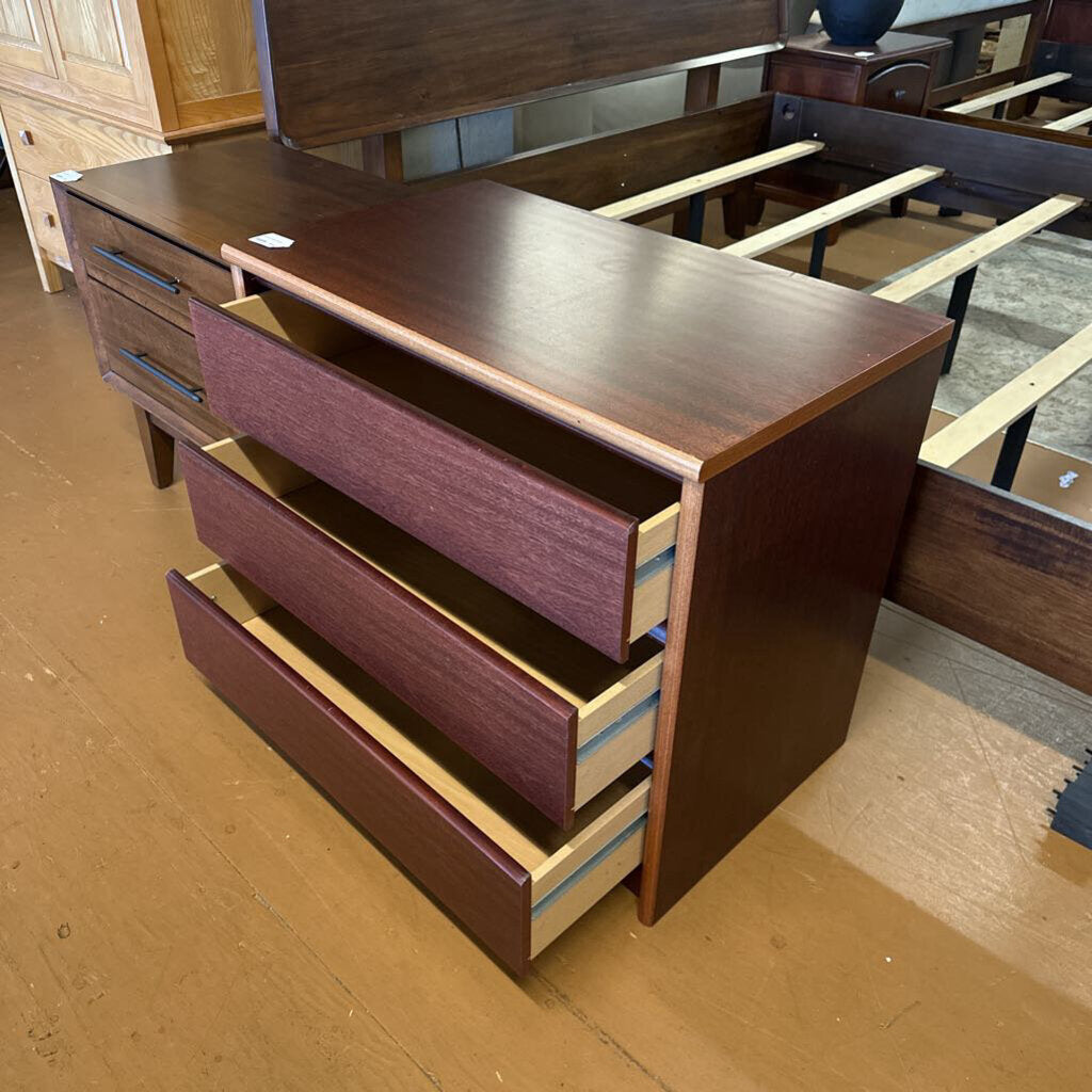 Wooden dresser with multiple drawers in a store setting