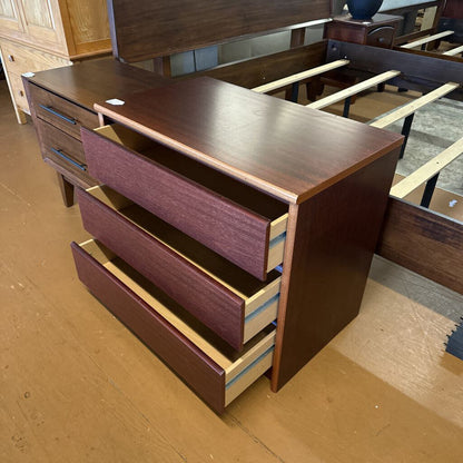 Wooden dresser with multiple drawers in a store setting
