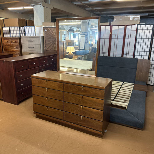 Wooden dresser with mirror in a furniture store setting