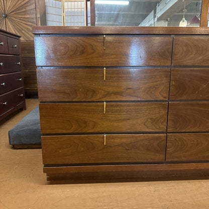 Wooden dresser with multiple drawers in a room setting