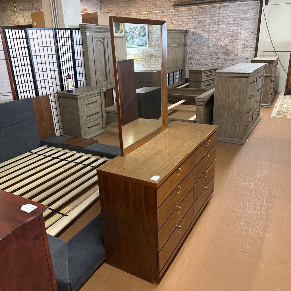 Wooden dresser with mirror in a furniture store setting