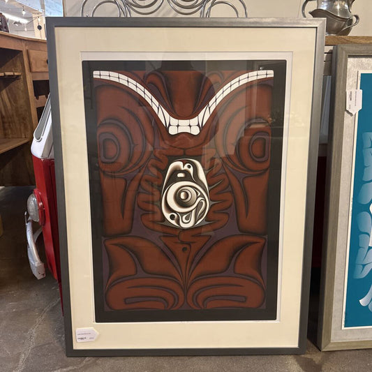 Framed artwork with a brown and white design on a table