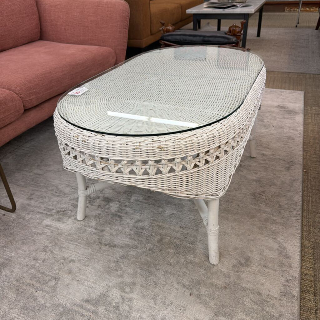 Wicker coffee table with glass top in a room setting