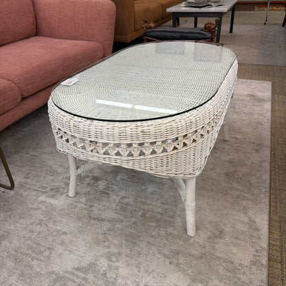 Wicker coffee table with glass top in a room setting