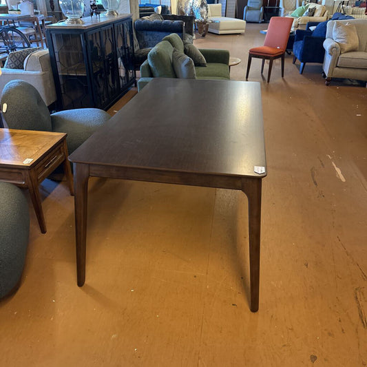 Wooden table in a room with chairs and furniture