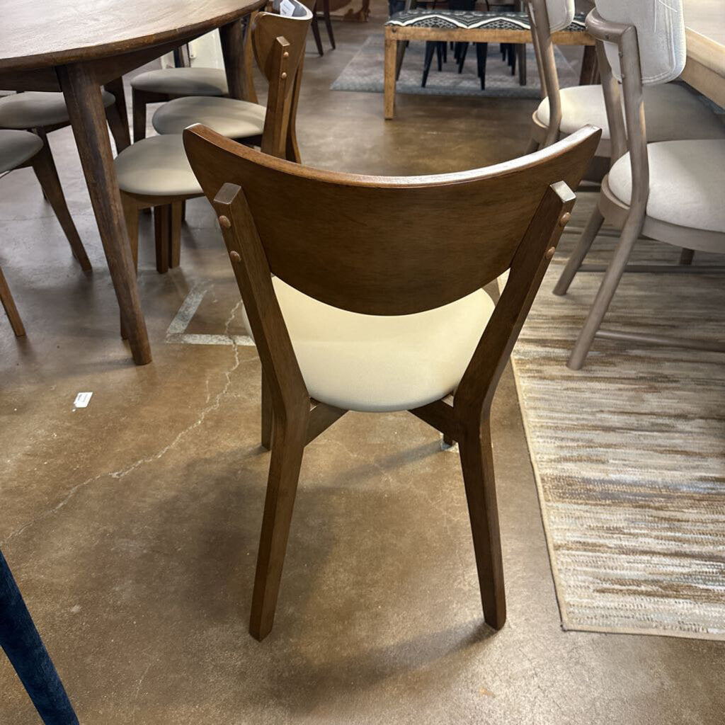 Wooden chair with a white cushion on a showroom floor