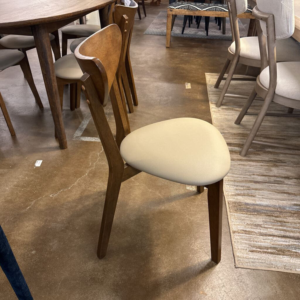 Wooden chair with a beige cushion on a showroom floor