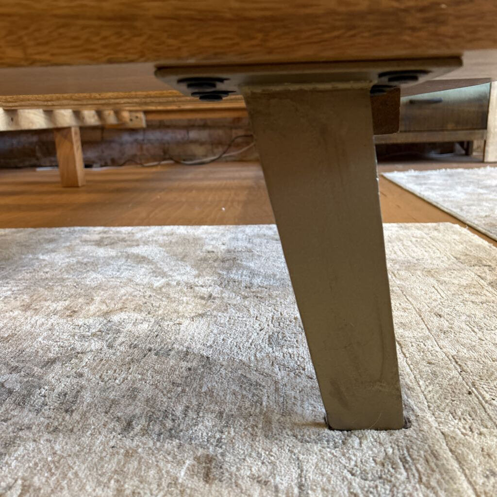 Wooden table leg on a carpeted floor