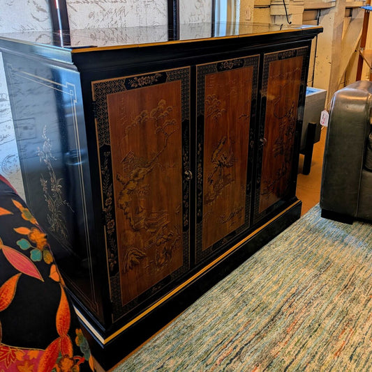 Wooden cabinet with black trim in a room setting