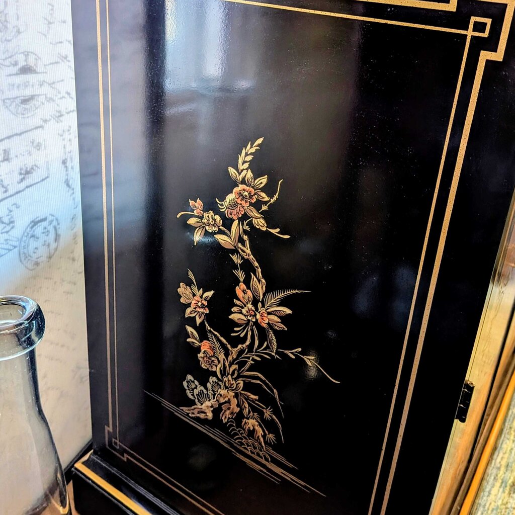 Decorative black box with floral embossing and gold accents