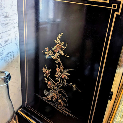 Decorative black box with floral embossing and gold accents
