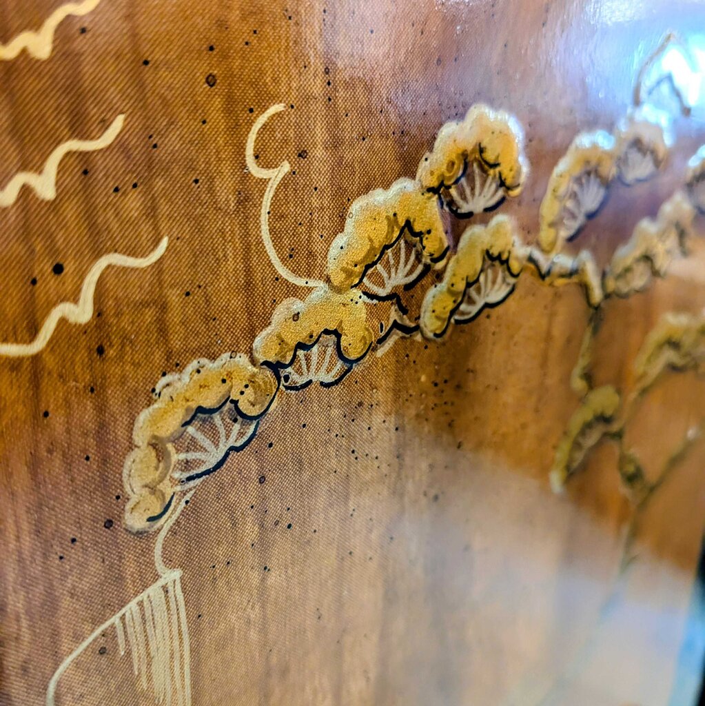 Close-up of embroidered yellow flowers on a wooden surface