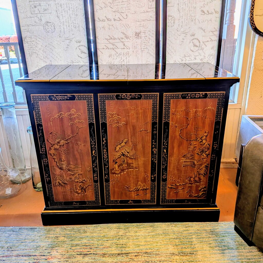 Decorative wooden cabinet with intricate carvings in a room setting
