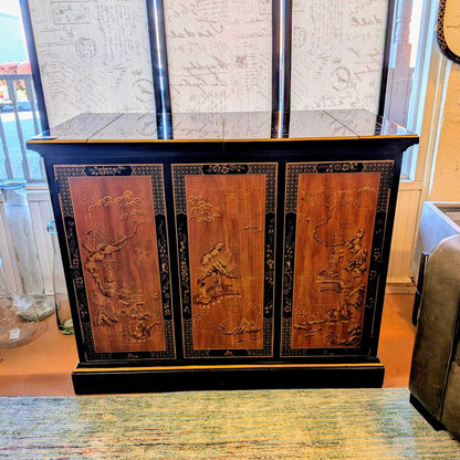 Decorative wooden cabinet with intricate carvings in a room setting