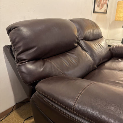 Brown leather sectional sofa in a living room setting.