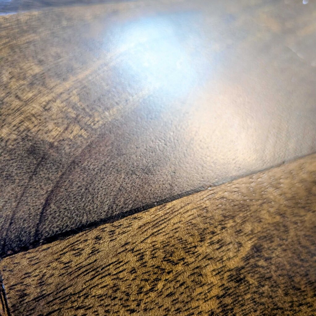 Close-up of a wooden surface with a reflective spot