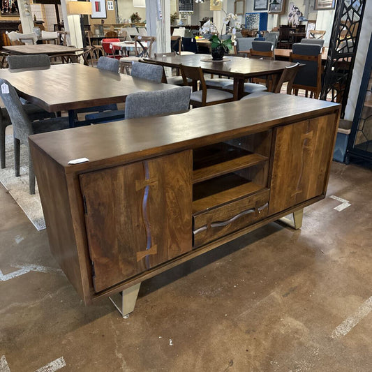 Wooden sideboard with cabinets and drawers in a furniture store setting