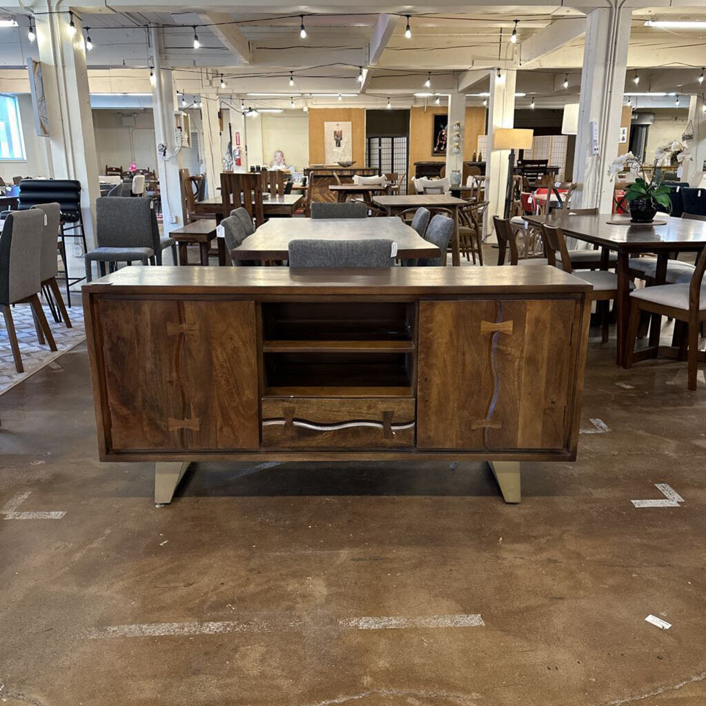 Wooden sideboard in a furniture store with tables and chairs in the background