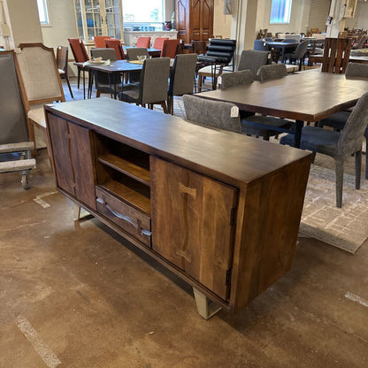 Wooden sideboard in a room with tables and chairs
