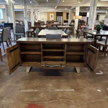 Wooden sideboard with open doors in a showroom setting
