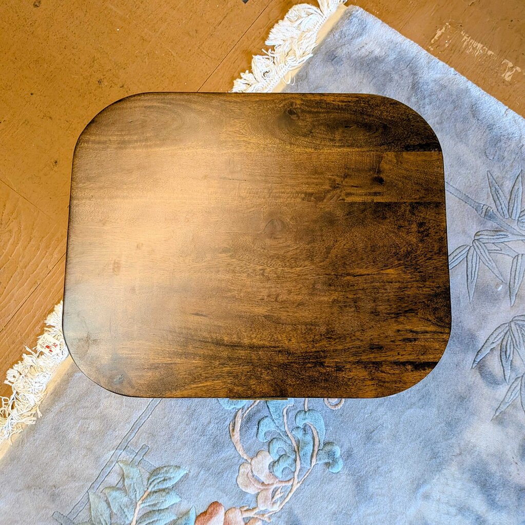 Wooden cutting board on a floral-patterned fabric background