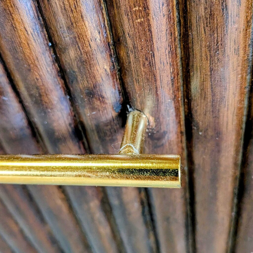 Gold handle on a wooden door