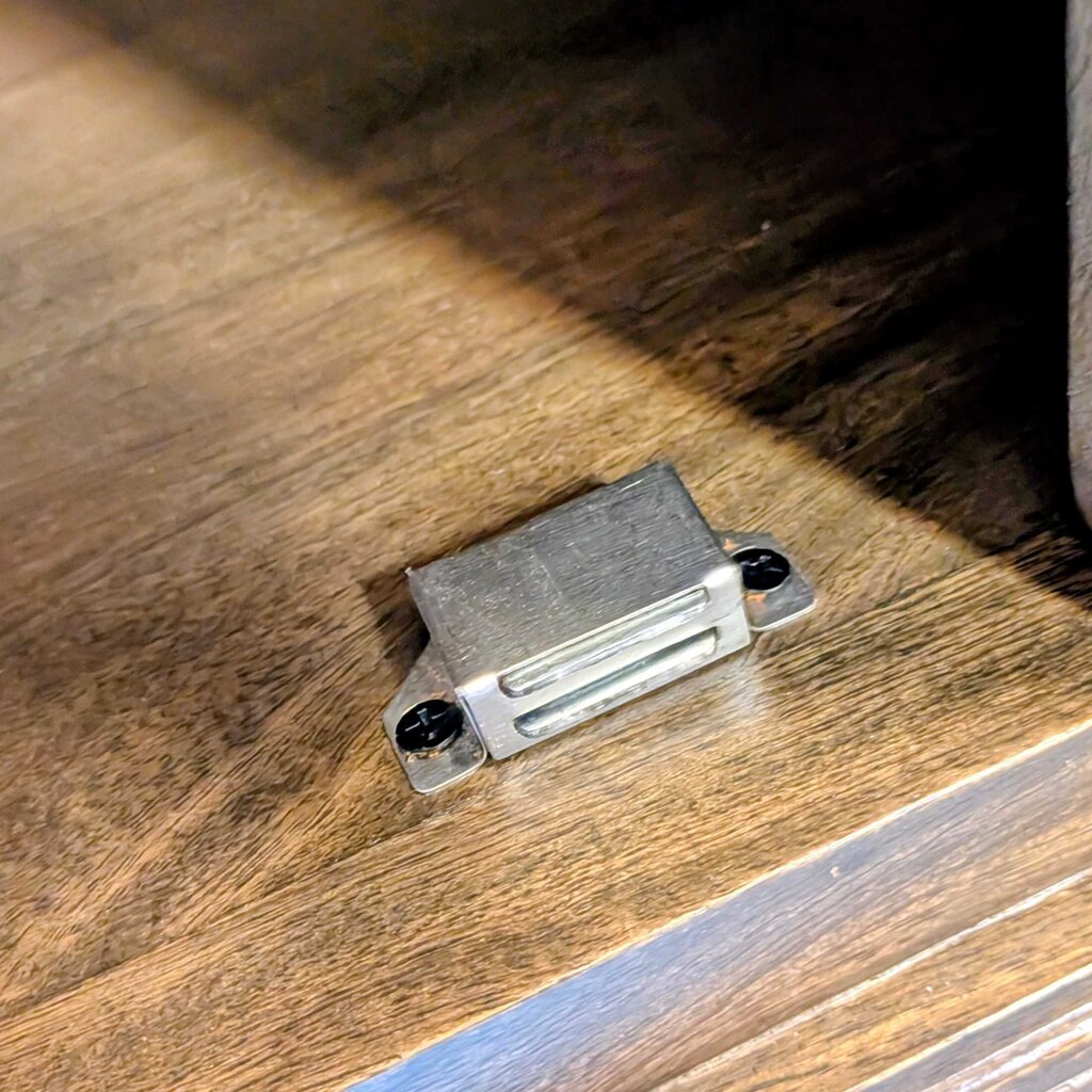 Small metallic object on a wooden surface
