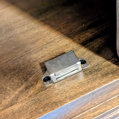 Small metallic object on a wooden surface