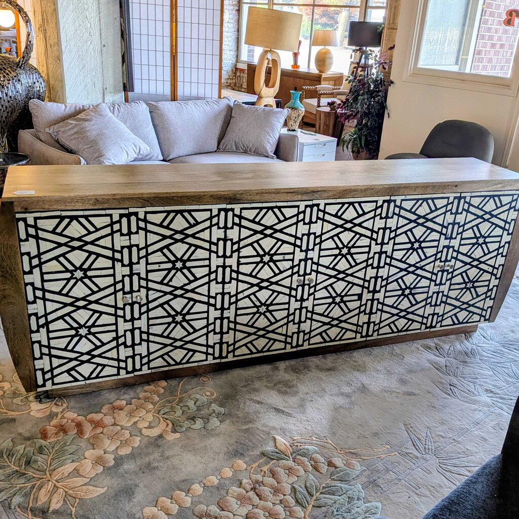 Wooden console table with geometric pattern in a living room setting