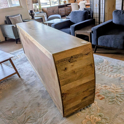 Wooden reception desk in a room with furniture and decor