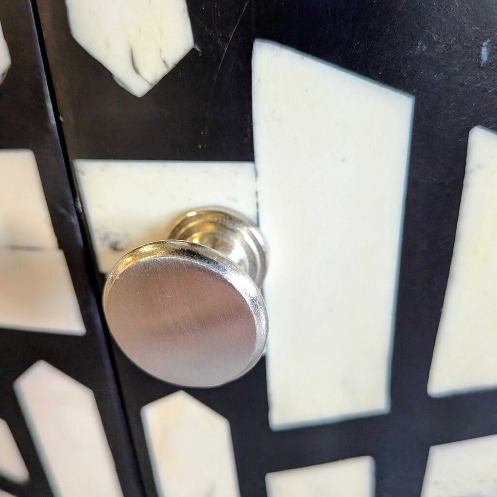 Close-up of a metallic knob on a textured surface