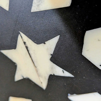 Star-shaped cookie cutters on a dark surface