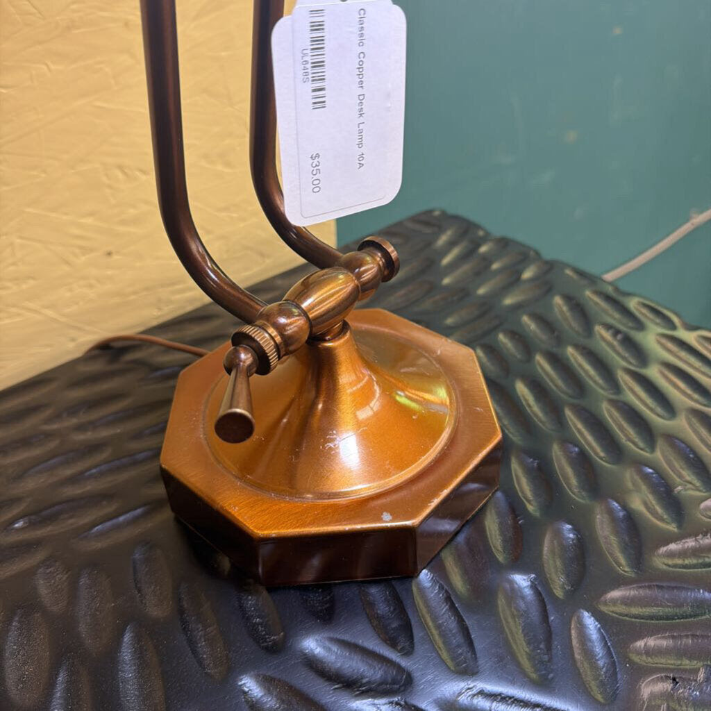 Vintage-style lamp with wooden base and brass accents on a textured surface.