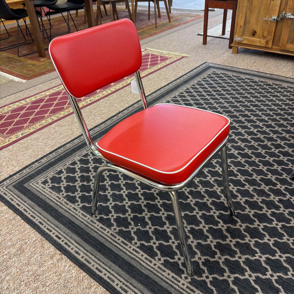 Red chair with a metal frame on a patterned rug