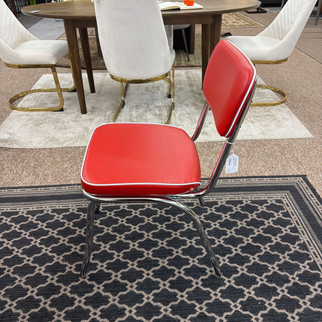 Red chair with metal frame on a patterned rug