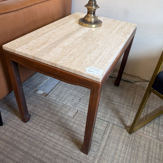 Small side table with marble top and wooden frame in a room setting.
