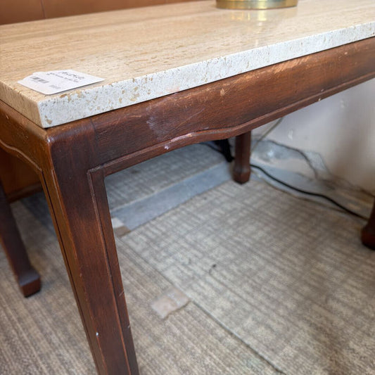 Wooden table with marble top on a carpeted floor