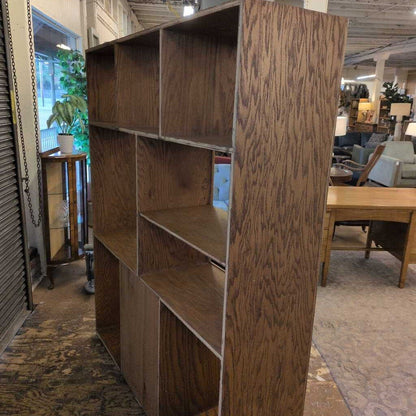 Wooden bookshelf in a room with furniture and decor