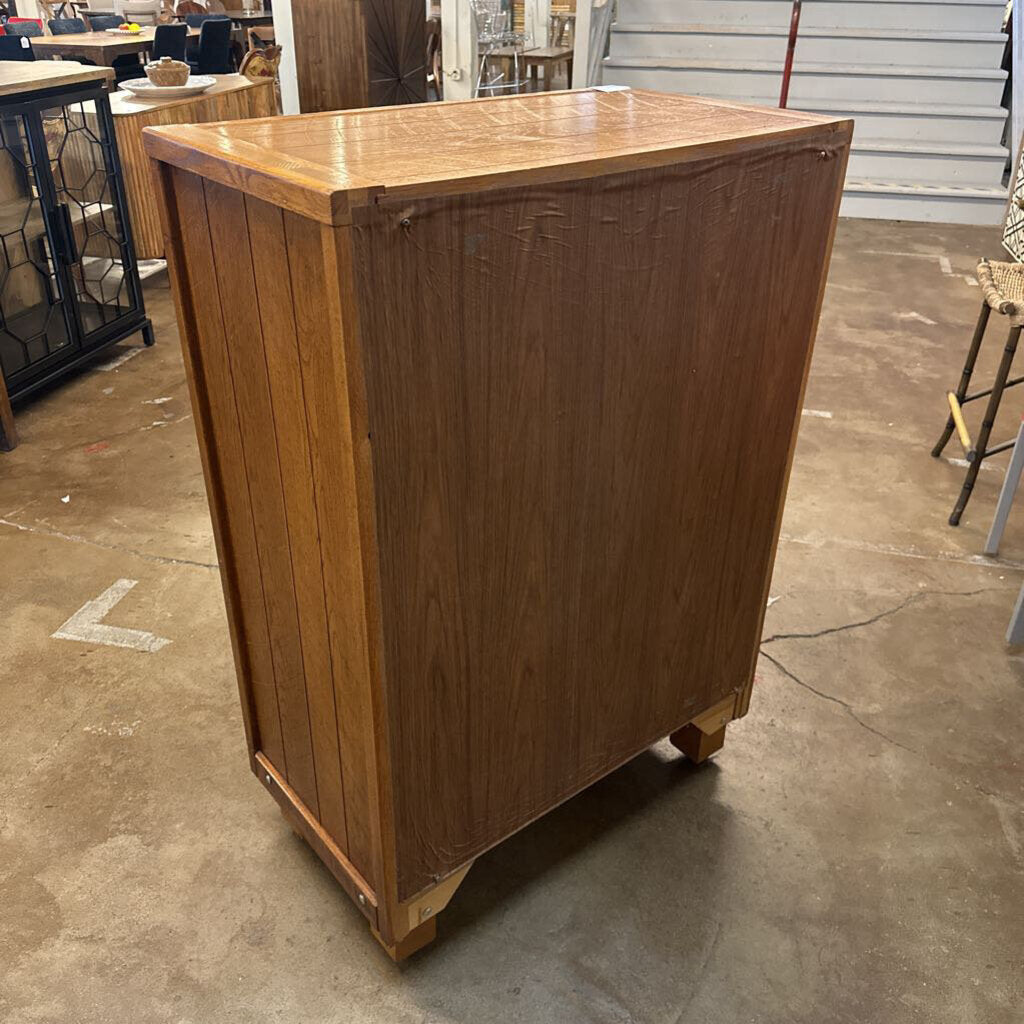 Wooden bar or counter on a concrete floor with chairs and tables in the background