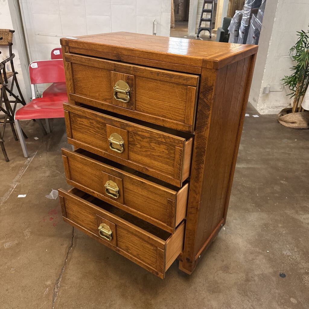 Wooden dresser with four drawers in a warehouse setting