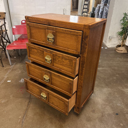 Wooden dresser with four drawers in a warehouse setting