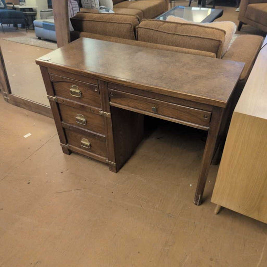 Wooden desk with drawers in a room with furniture