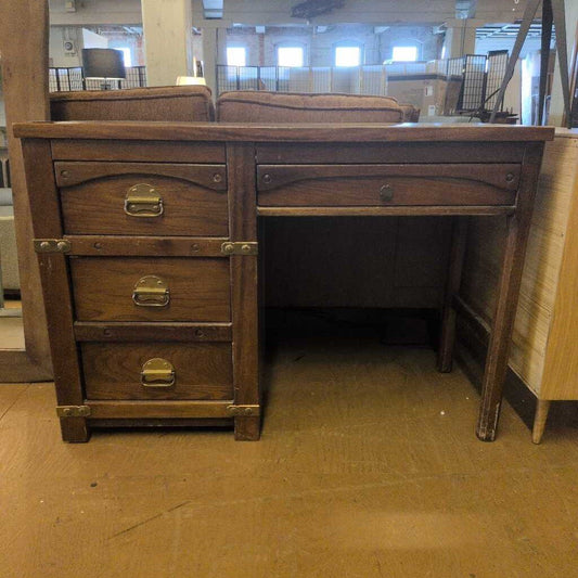 Wooden desk with drawers in a warehouse setting