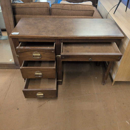 Wooden desk with multiple drawers in a room setting