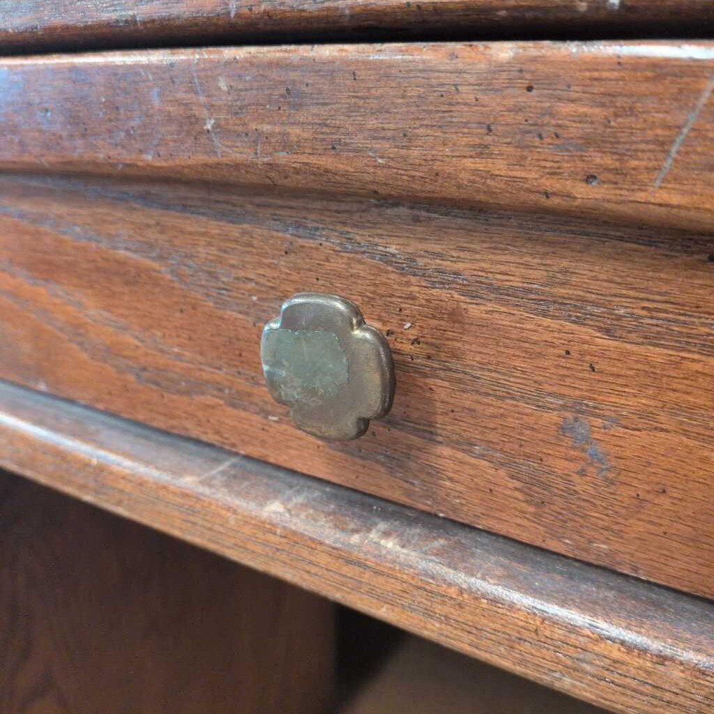 Close-up of a wooden drawer with a metal knob