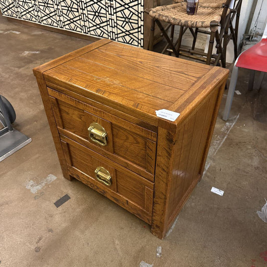 Wooden chest with gold handles on a concrete floor