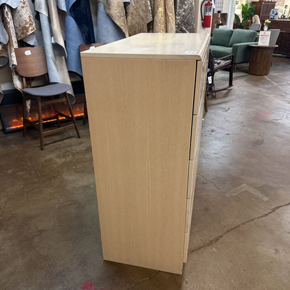 Wooden cabinet in a store setting with furniture and decor items in the background