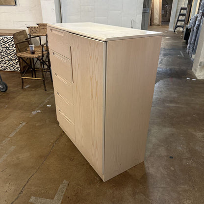 Beige metal file cabinet in a warehouse setting